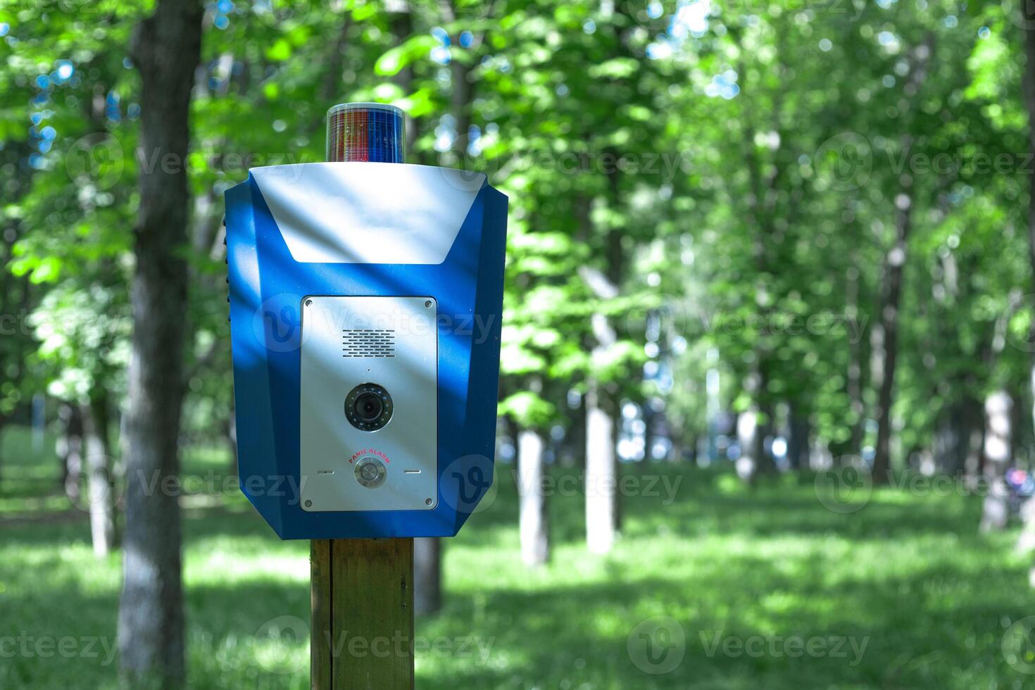 blue box with alarm button in the park to call the police photo