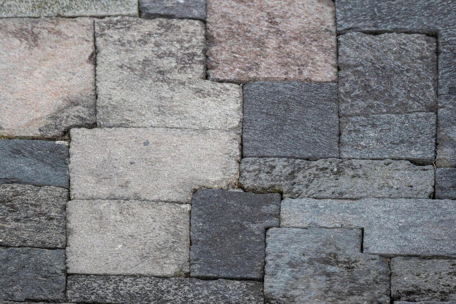 Close-up of interlocking stone blocks with various shades and textures. photo