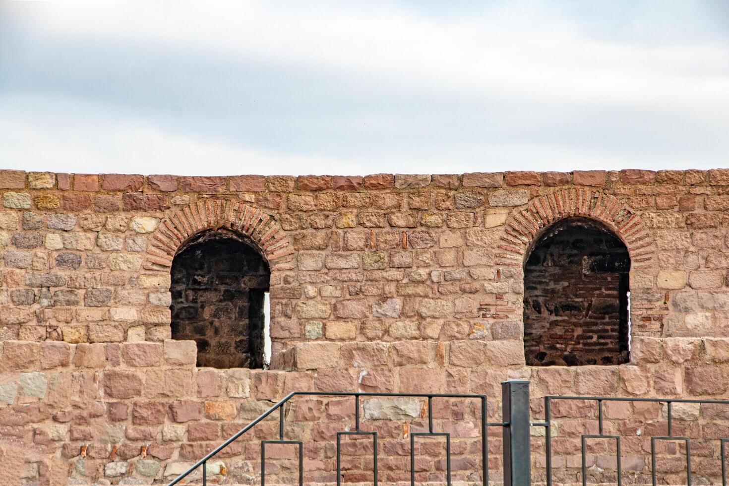 Ancient Stone Wall with Arched Openings A Glimpse into History photo
