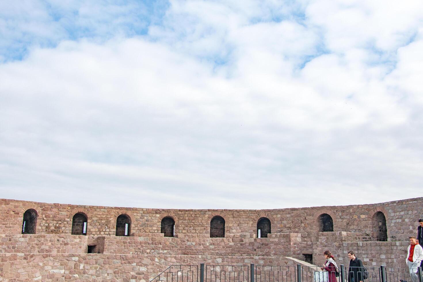 Ancient Fortress Wall Exploring History Under a Cloudy Sky photo