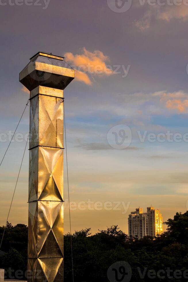 Shiny steel smokestack and cloud in twilight sparkle photo