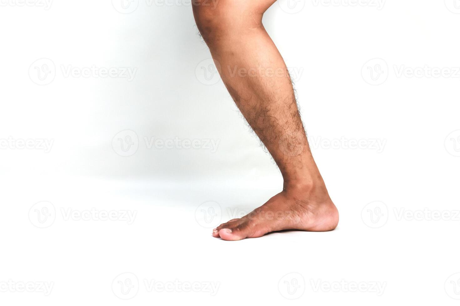 Close-up of a person's leg and foot against a white background showcasing lower limb anatomy photo