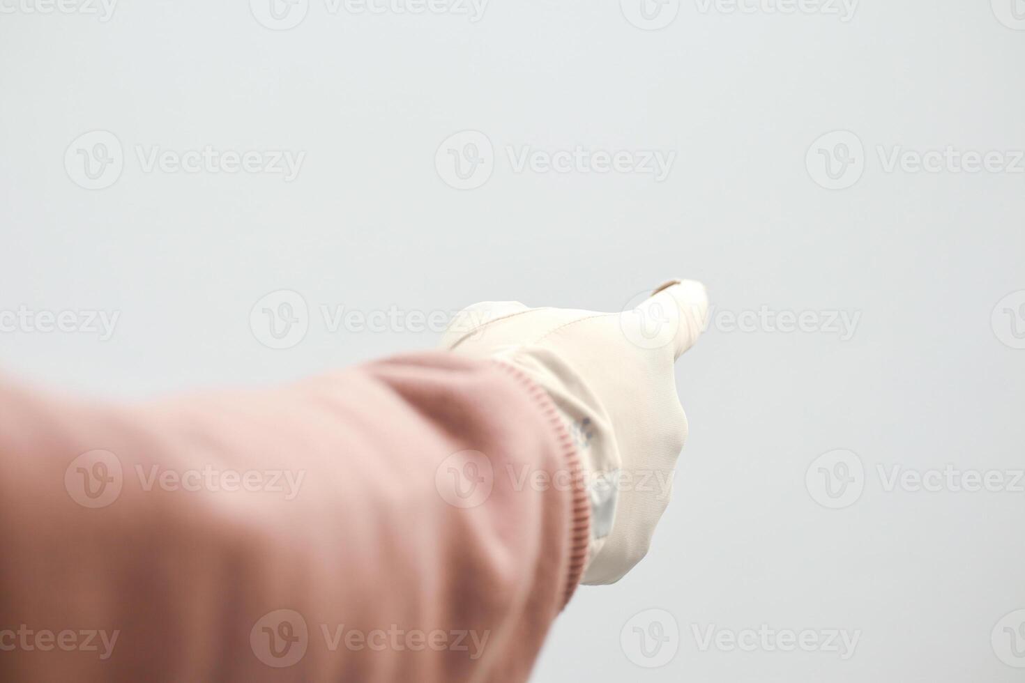 Hand in white glove pointing on a white background, indicating a direction or selection with outstretched arm photo