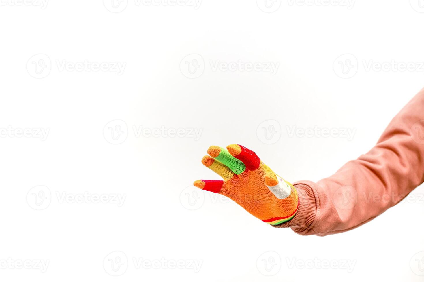 A hand wearing a colorful glove extending outwards against a white backdrop, showcasing playful creativity and vibrancy photo