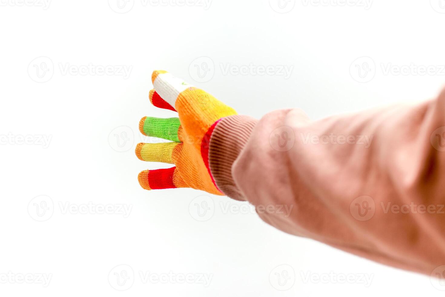 Hand wearing colorful touch screen gloves on a white background in studio shot photo