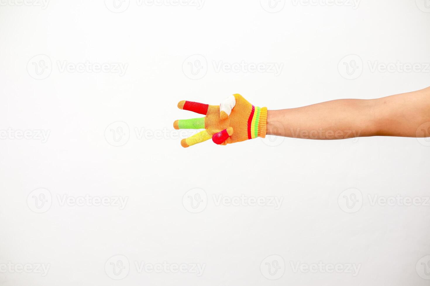 Arm wearing colorful novelty finger puppets on white background for kid concepts photo