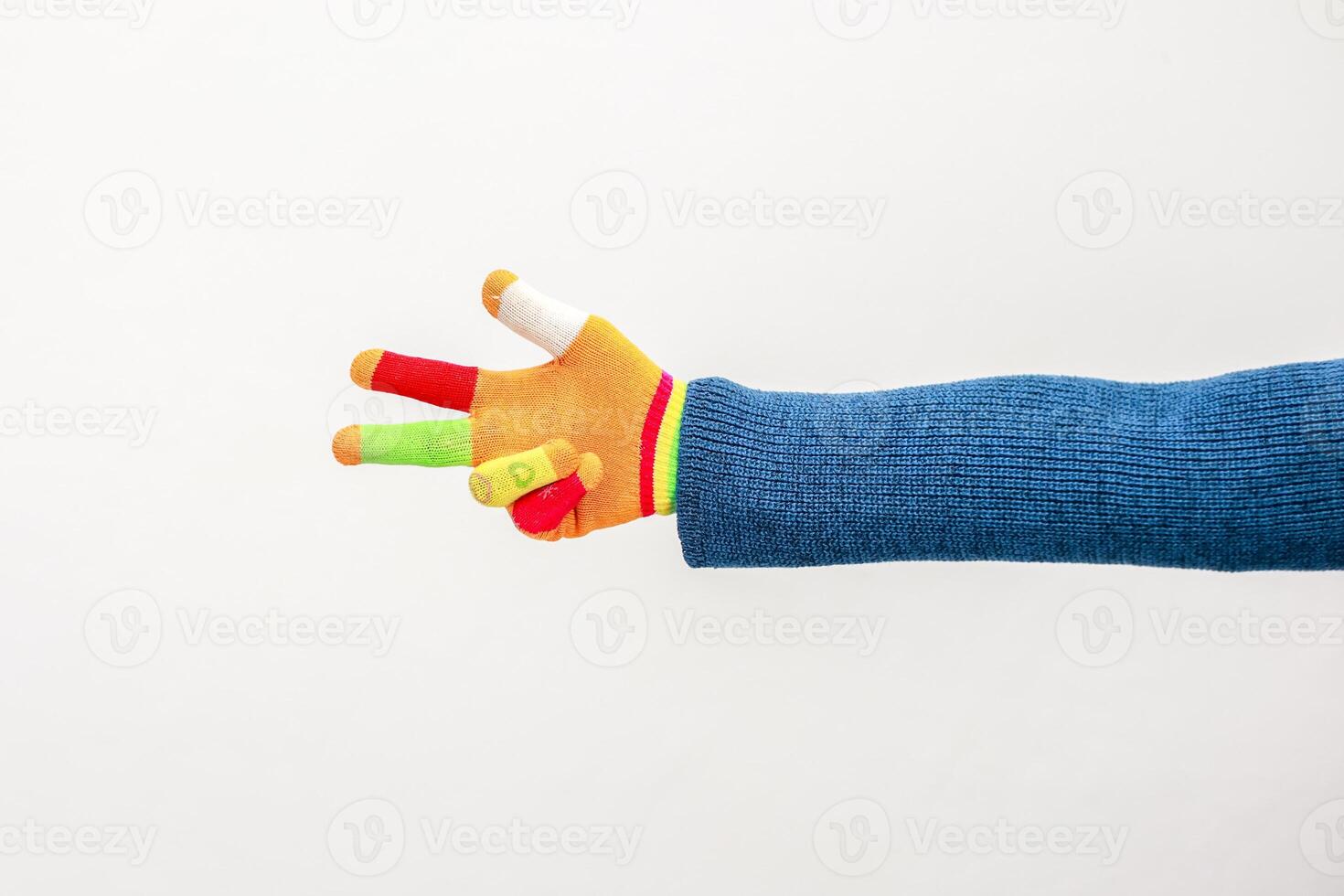 A playful gesture with a colorful knitted hand, symbolizing peace and vibrancy photo
