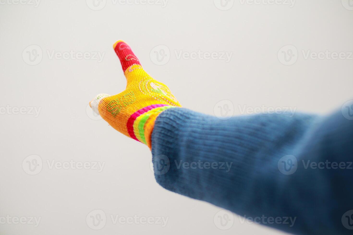 A Colorful Knitted Glove Highlights Direction and Emphasis photo