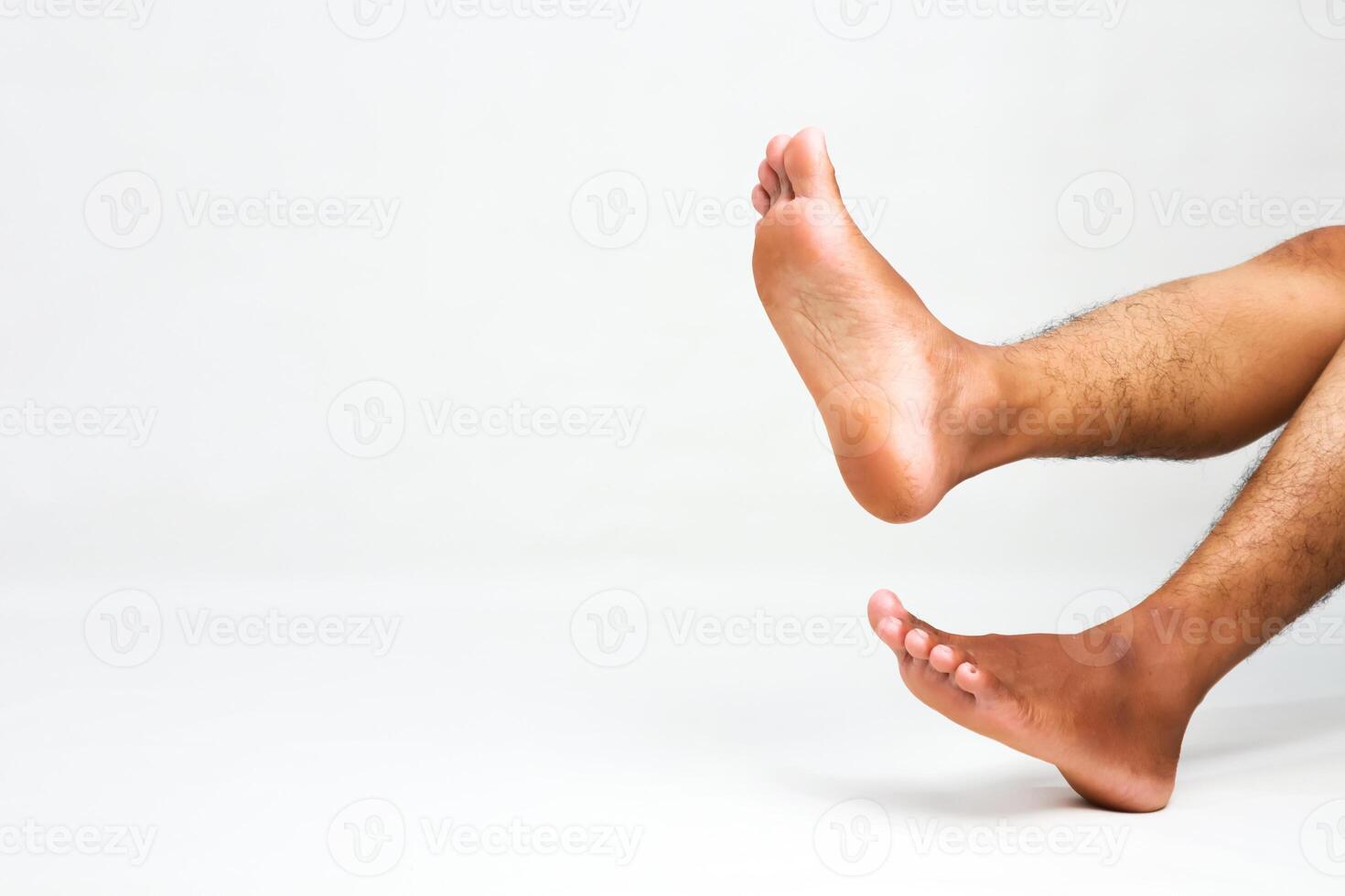 Legs in the air on white backdrop portraying relaxation and wellness concept photo