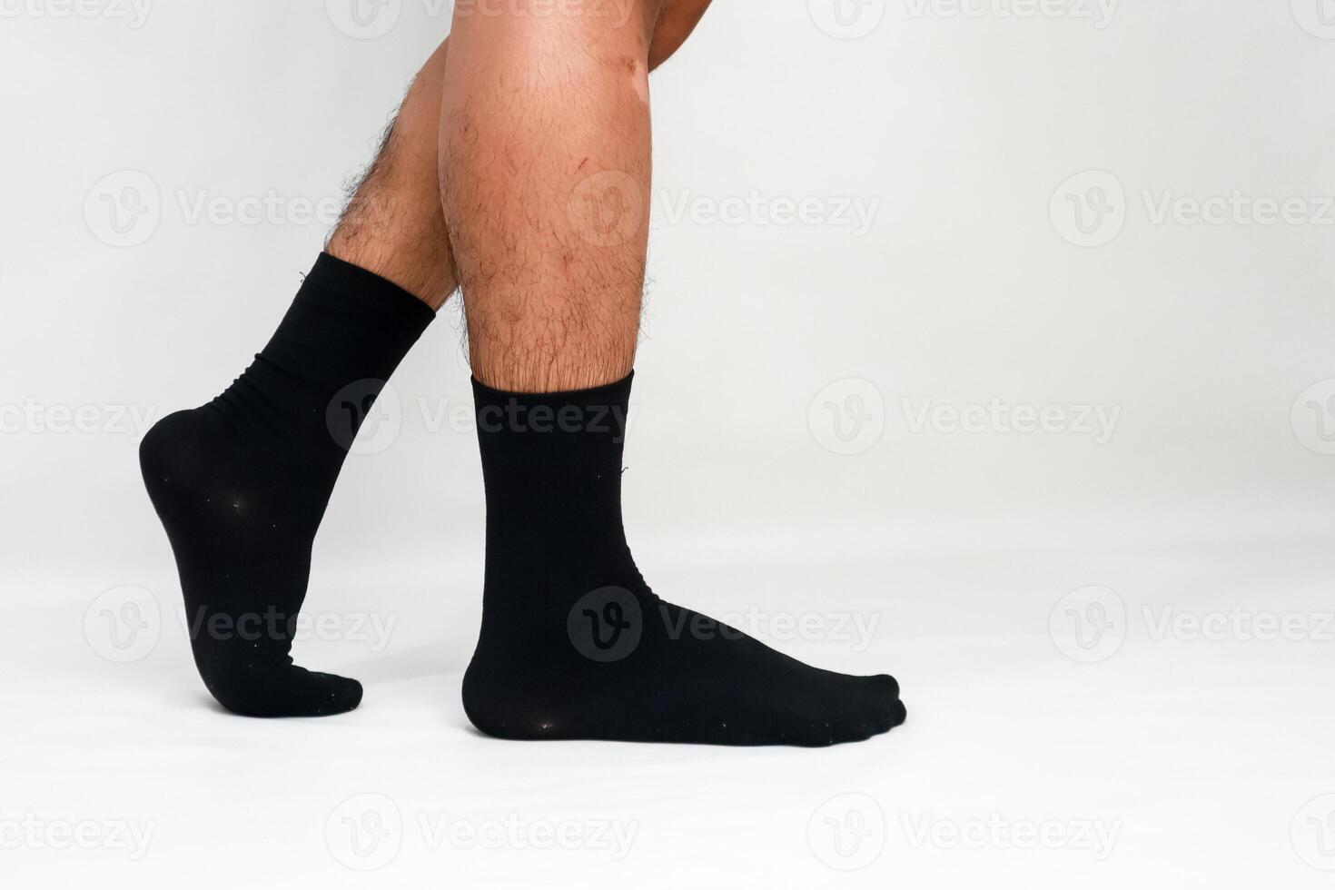 Man wearing black socks on a white background, showcasing comfort and style for footwear enthusiasts and fashion designers photo