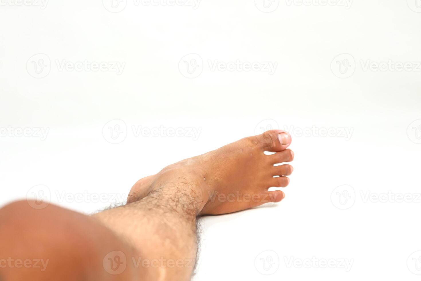 Human Foot and Leg Resting on a White Background Showcasing Anatomy and Skin Tone Diversity photo
