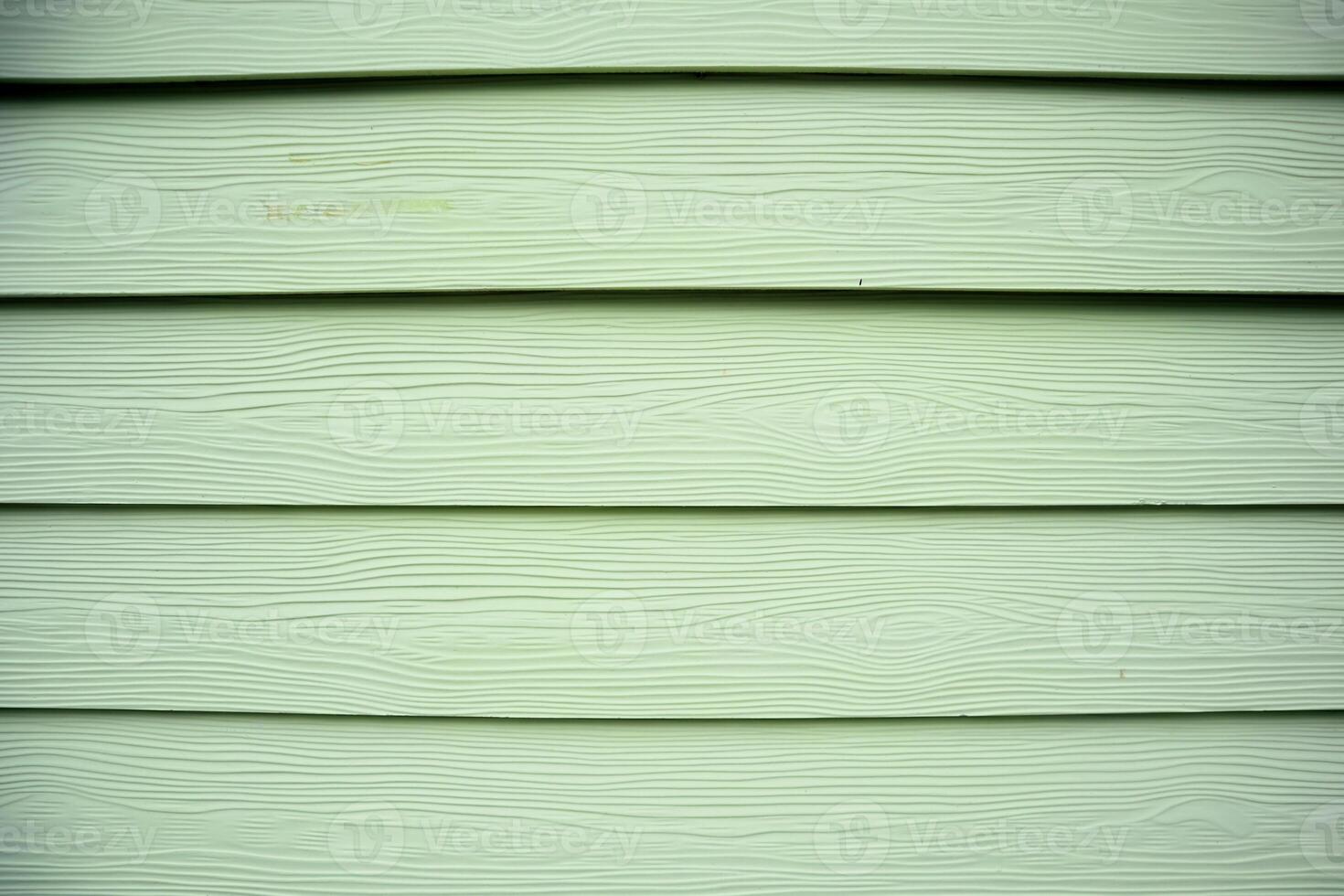 Close-up of Pale Green Wood Siding with Horizontal Lines and Subtle Wood Grain Texture, Suitable for Backgrounds photo