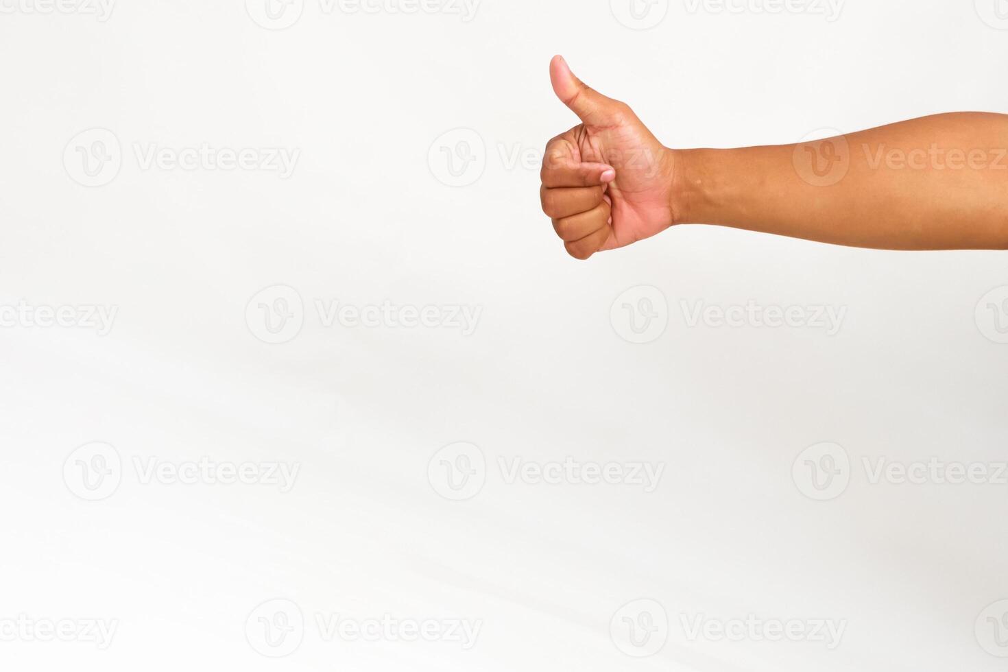 Hand gesture showing thumbs up on white background, concept of approval and agreement, successful sign photo