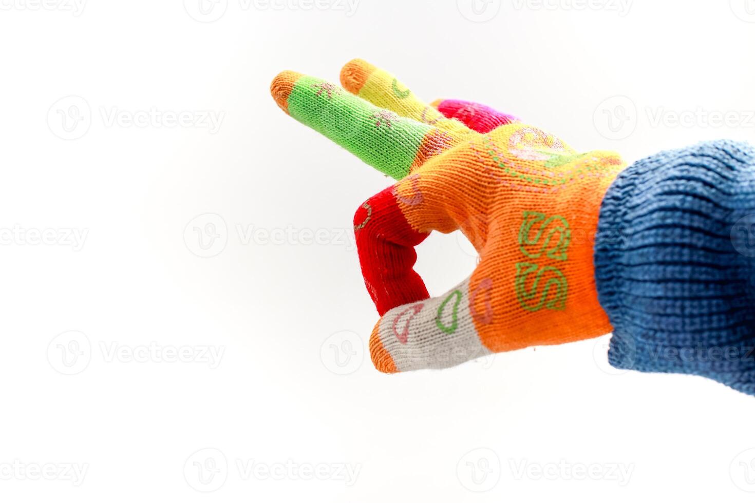 Close-up of a person wearing a colorful gardening glove with fingers extended against a white background photo