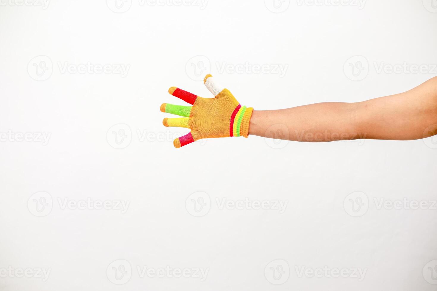 Isolated shot of a person's arm extending with a colorful hand glove against a white background photo
