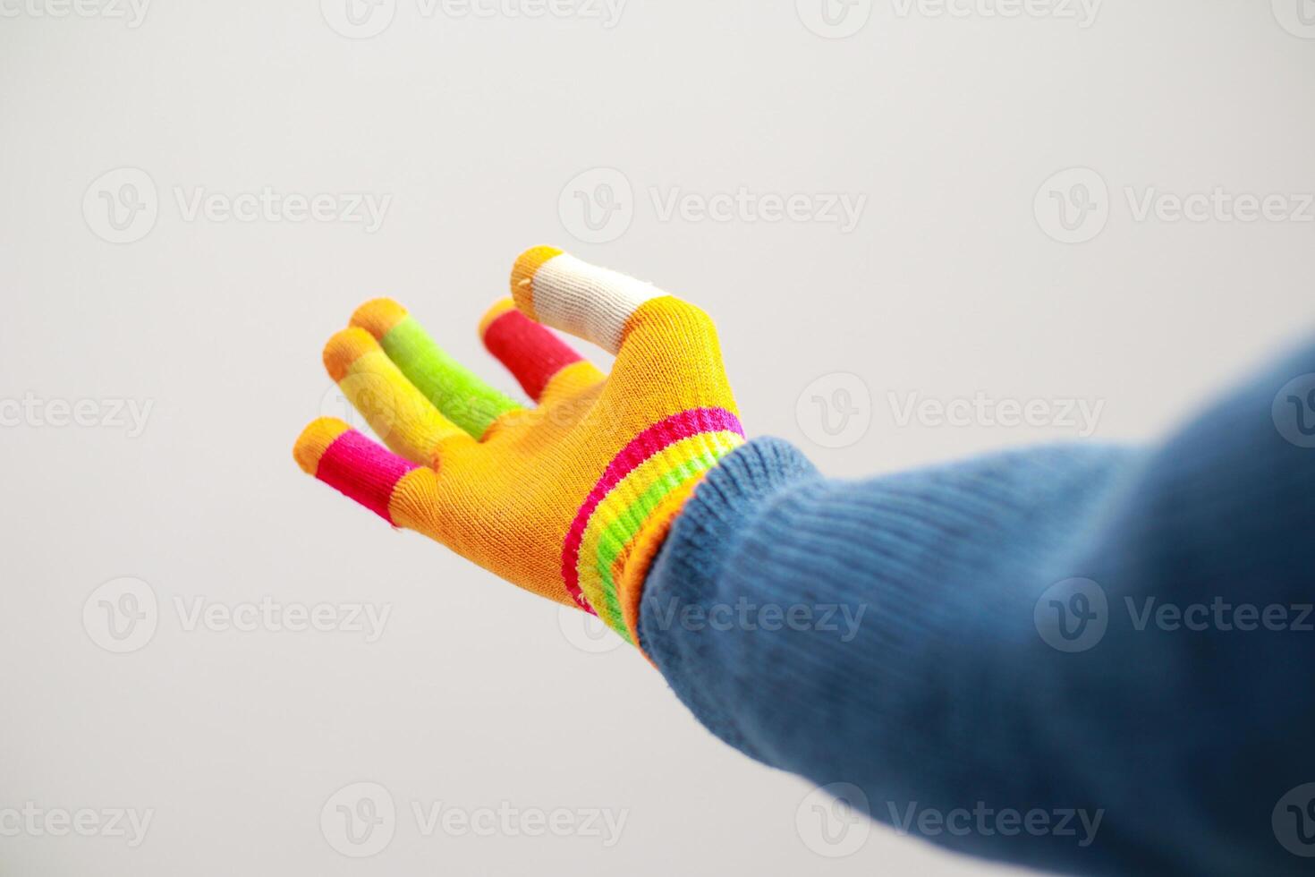 A brightly colored glove with individual finger sheaths outstretched in gesture photo