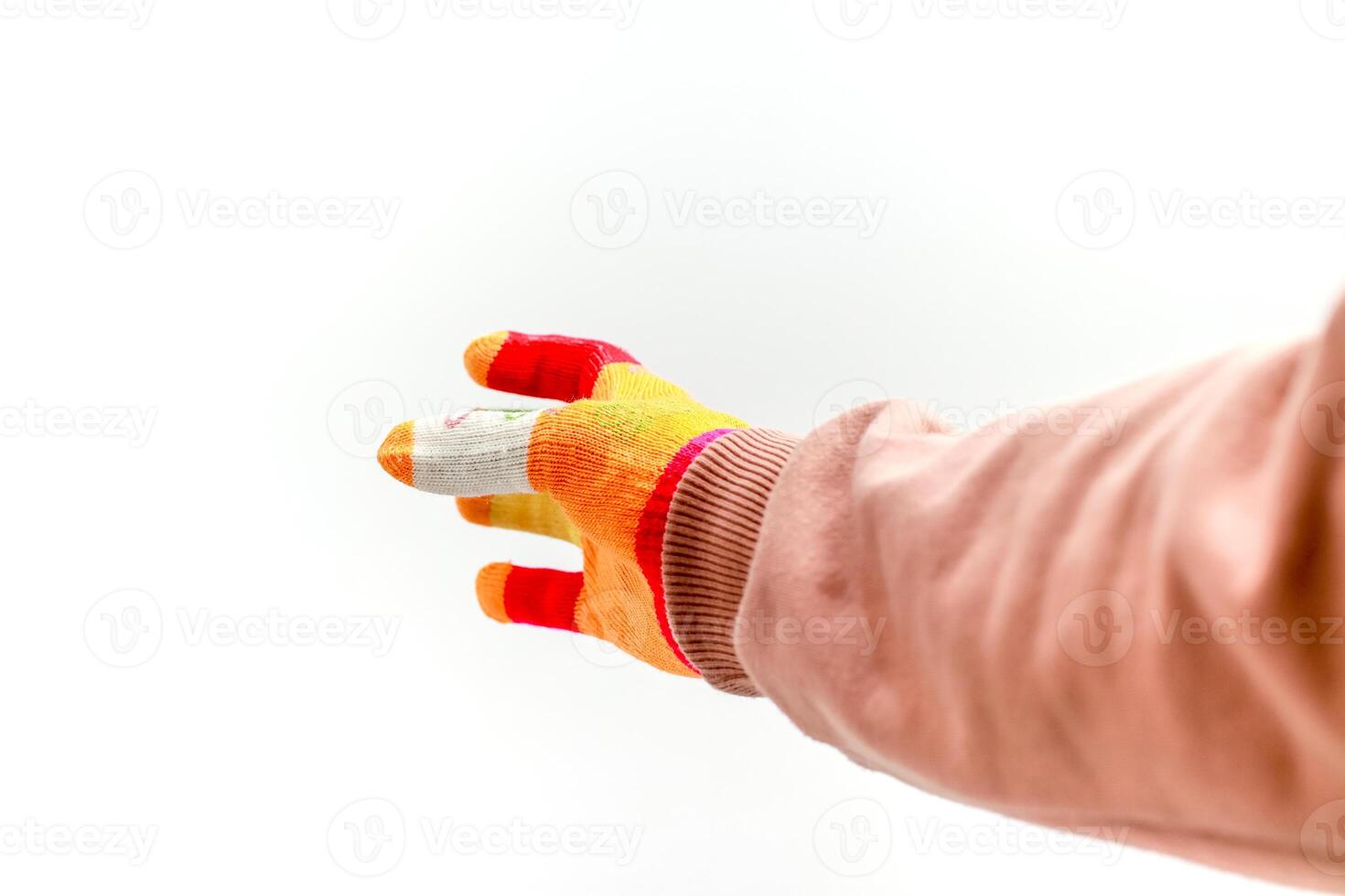 A gloved hand reaches out, with a bandaged finger, against a stark white background, offering assistance photo