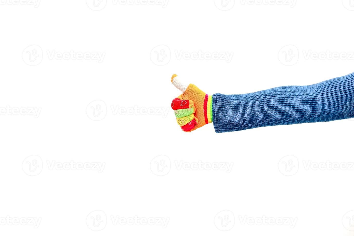 Thumbs up gesture with colorful glove on a blue sleeve against a white background, symbolizing approval photo