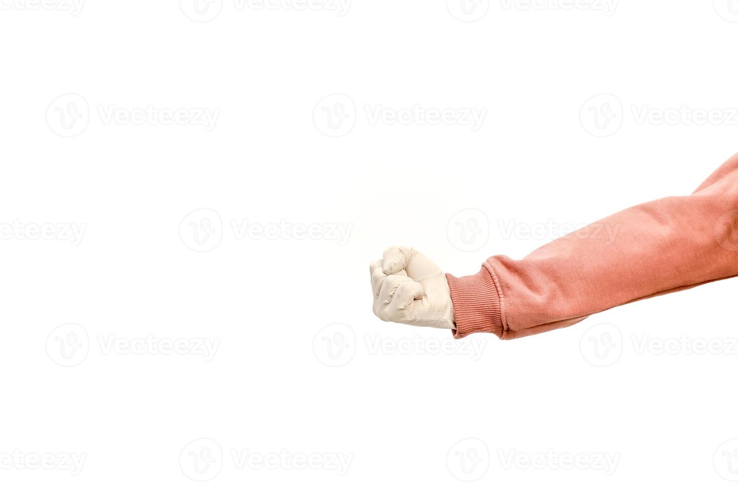 Studio shot of arm with clenched fist and a peach-colored sweatshirt sleeve on white photo