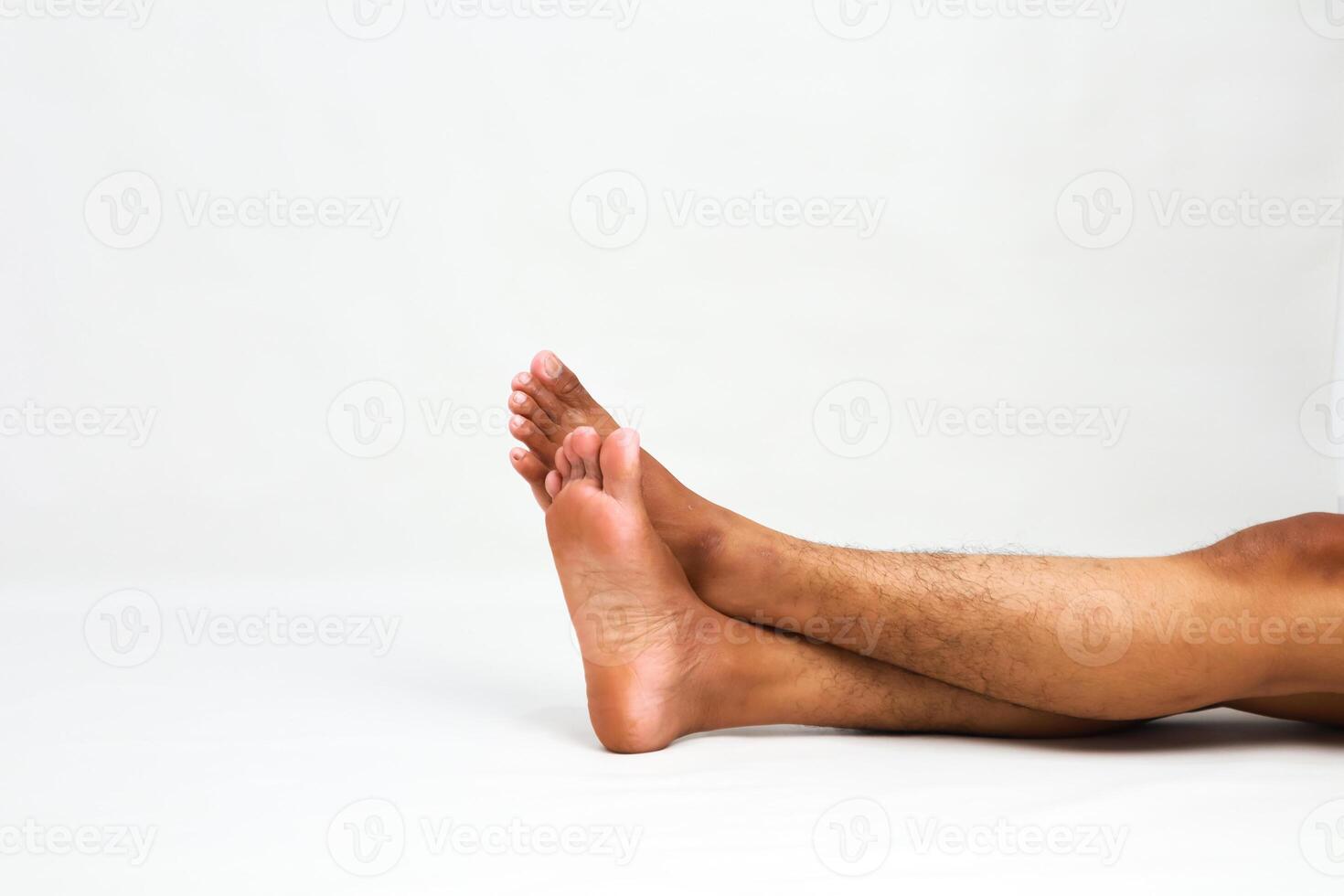 Relaxed African American Man's Legs and Feet Crossed on a White Background, Showing Comfort and Leisure photo