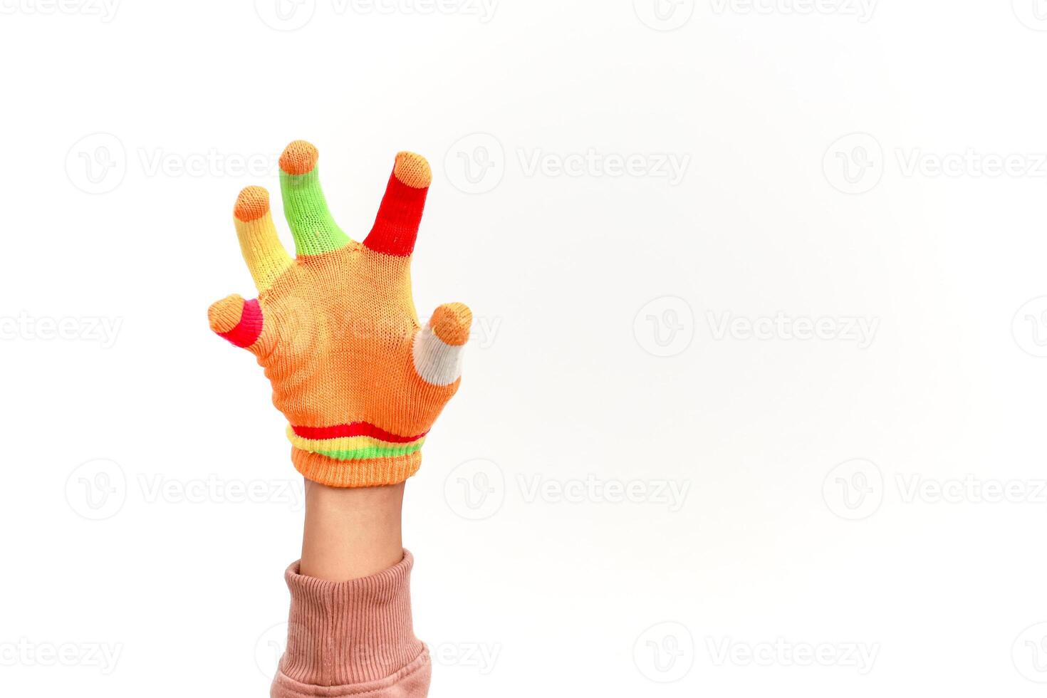 Colorful hand with a knitted glove on a white background expresses joy and playfulness photo