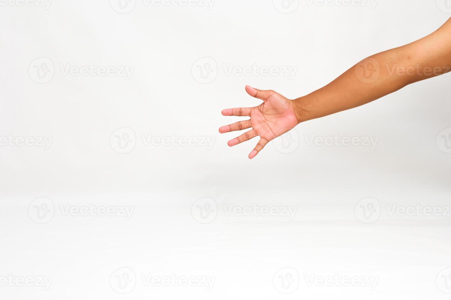 Isolated outstretched human hand with brown skin reaching out on white background, for use as template photo