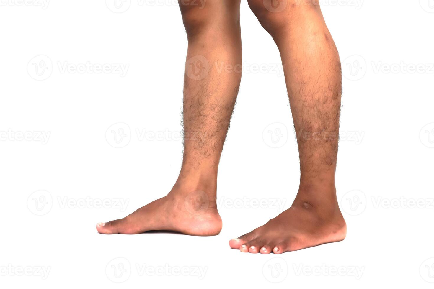 Close-up Studio Shot of Brown Skinned Man Standing with Bare Feet on a White Background photo