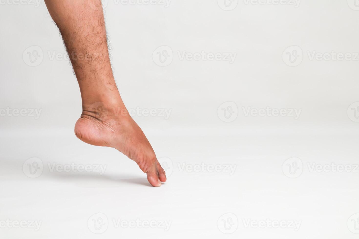 A close-up shot of a human foot delicately touching a clean white surface emphasizing poise and balance photo