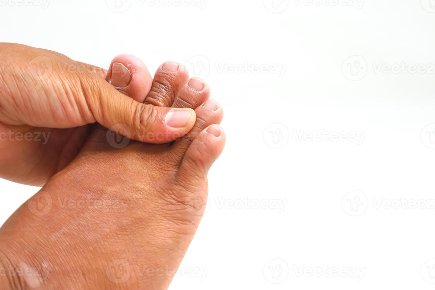 Foot and hand massaging toes for foot pain or illness with a white background. Could be toe injury or medical treatment concept photo