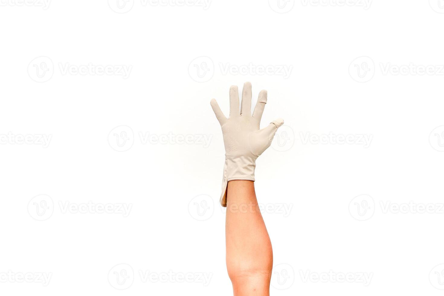 Hand wearing a surgical glove reaching up against a clean white background symbolizing protection photo