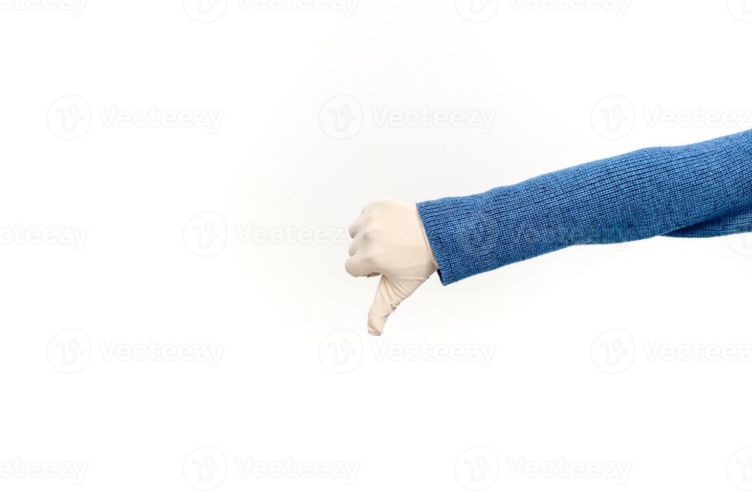 Hand in glove giving thumbs down, concept of disapproval or negative feedback, isolated on white photo
