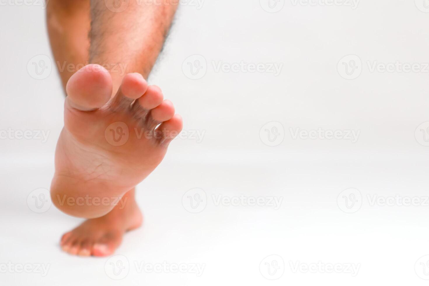 Close-up of a Man's Foot on White Background, Purity and Cleanliness Concept photo