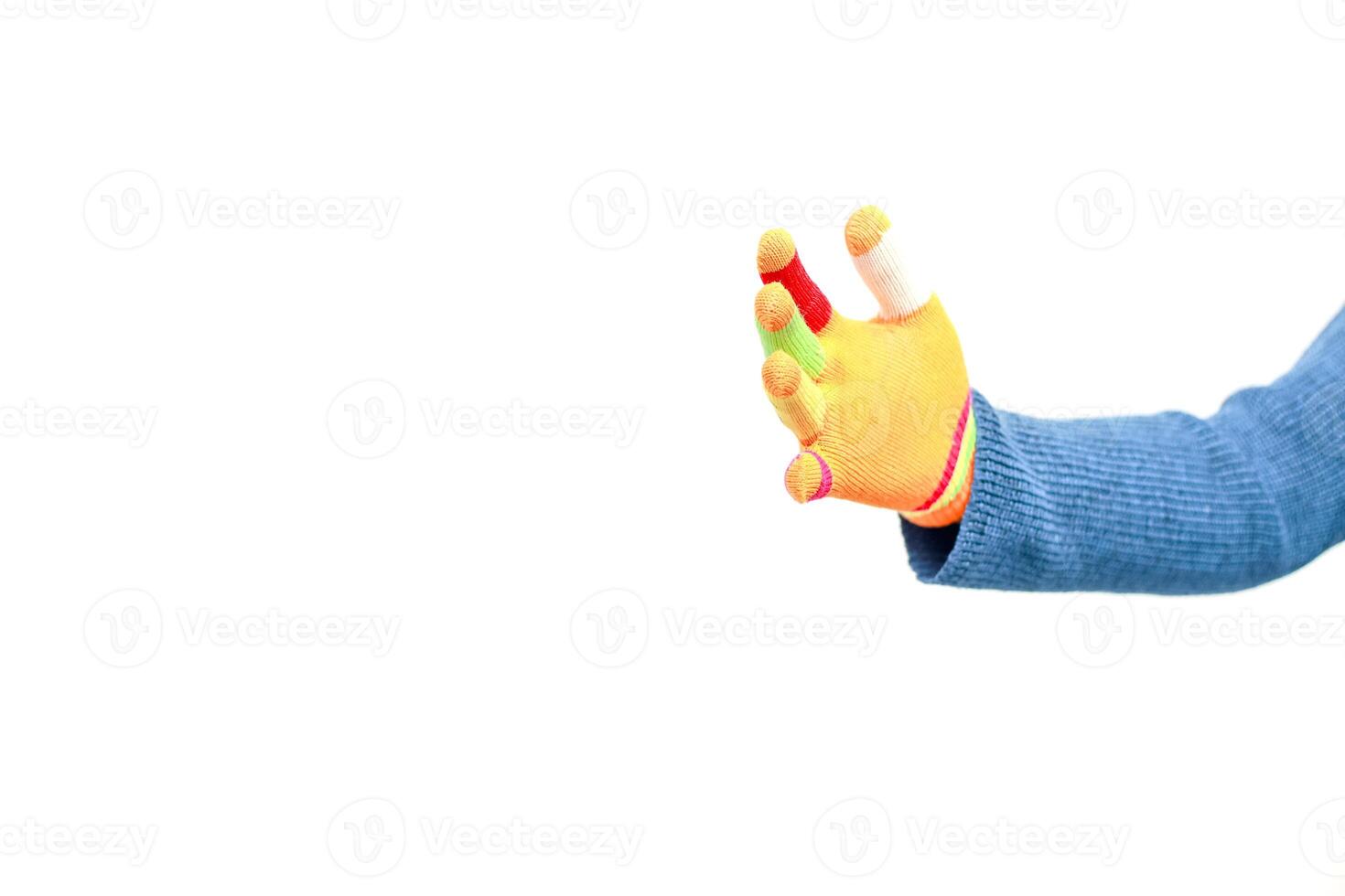 Isolated image featuring a hand wearing a colorful knitted glove against a plain white background showcasing vibrant finger tips photo