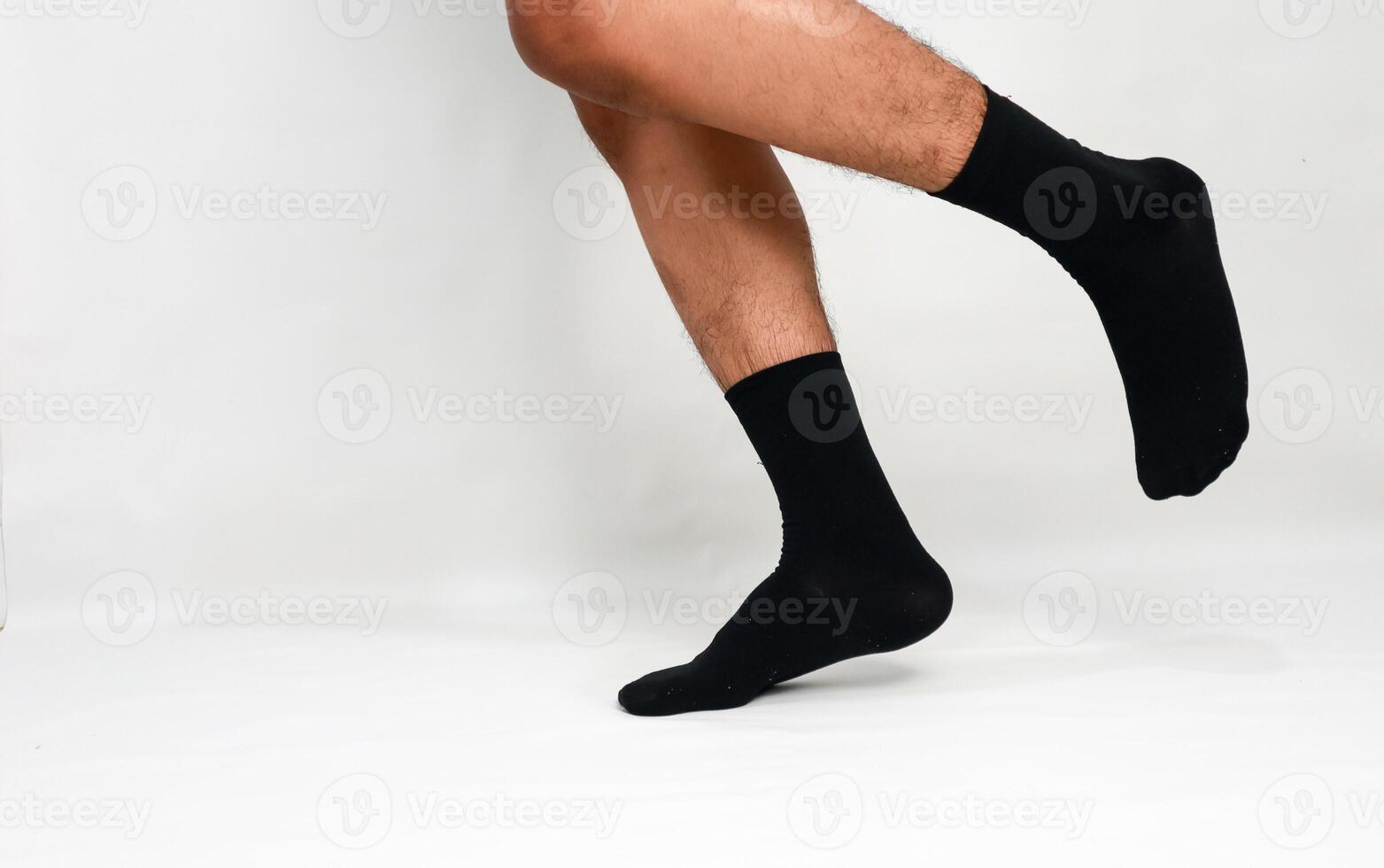 Legs wearing black socks in motion against a white background, illustrating athleticism and modern minimalistic style photo