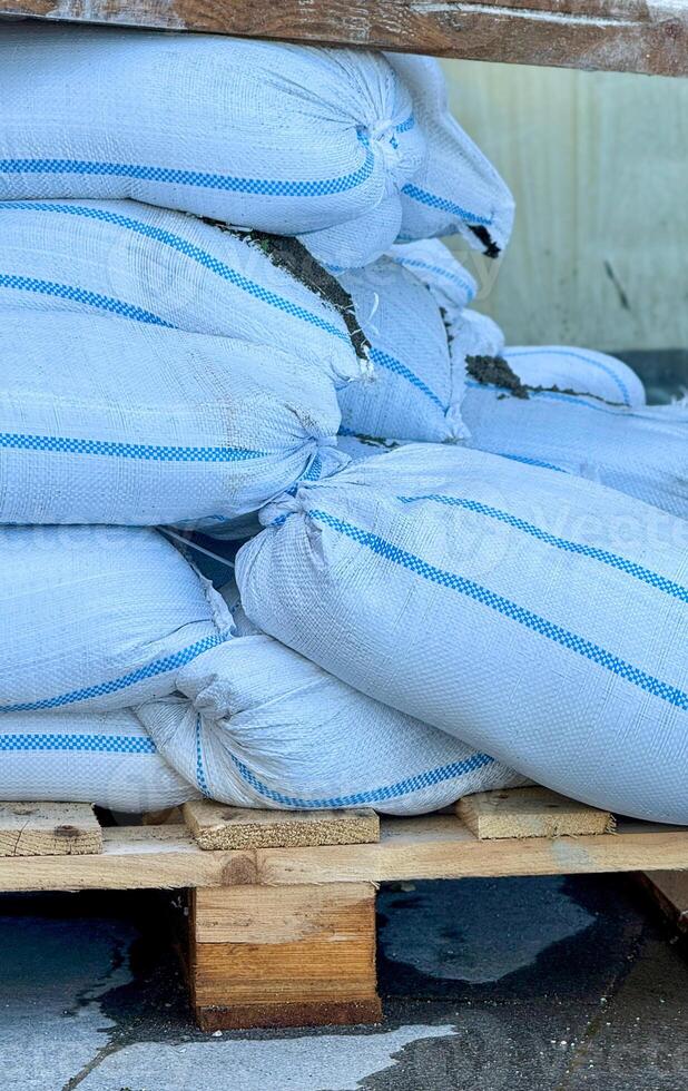 Stacked Industrial Bags on a Wooden Pallet with Spillage photo