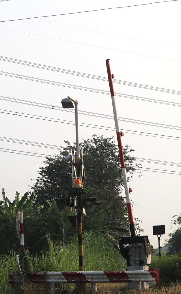 A train crossing with a light pole photo