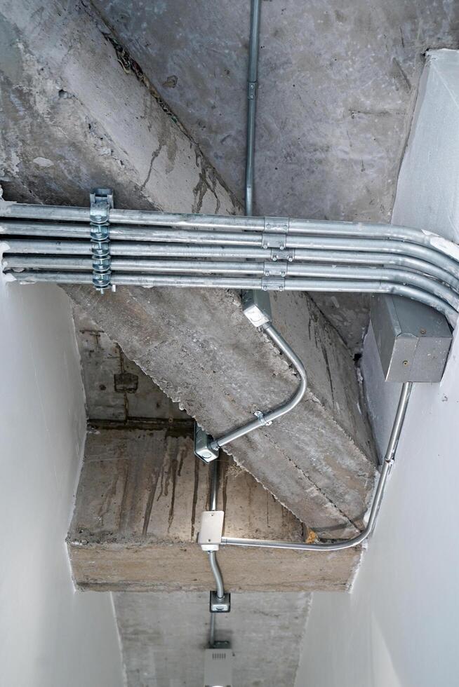 Interior architecture and design of concrete cement loft ceiling decorated with metal pipe and hanging industrial lamp photo