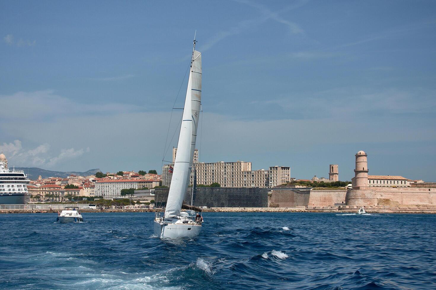 Marseille, France, June 1, 2025,Sailing on the French Riviera with a sailboat in the foreground and multiple boats near Marseille, Provence photo