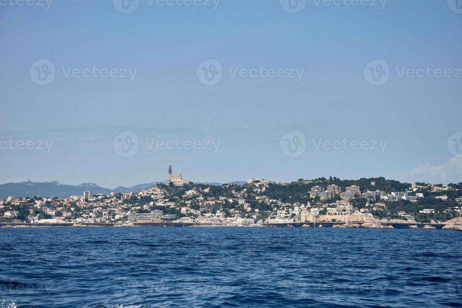 Evening on the French Riviera, Lights of Marseille reflected in the Mediterranean, with the MUCEM illuminated. photo