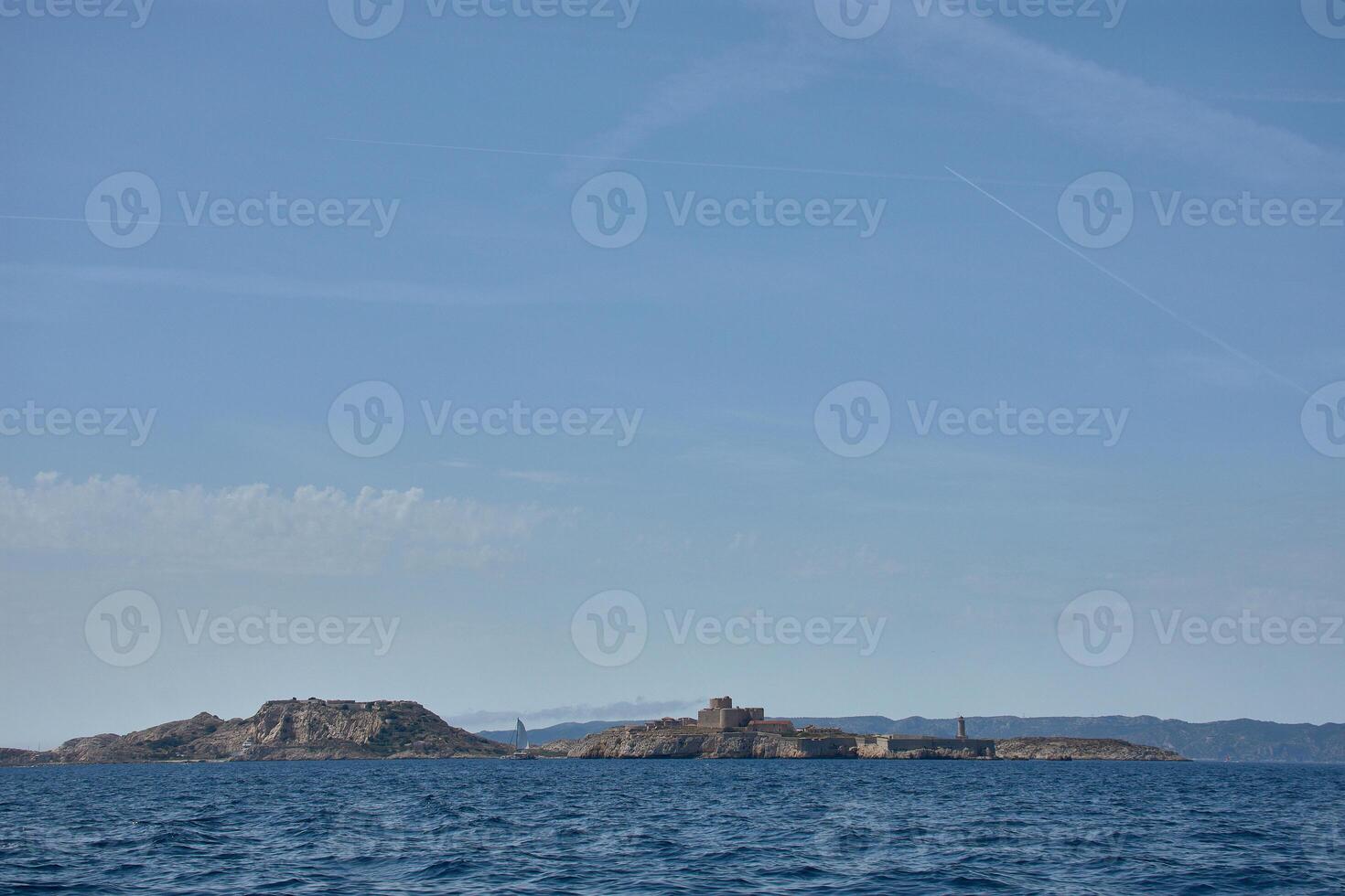 Chateau d'If in the Bay of Marseille, a stone fortress on a cliff in the Frioul Archipelago at sunset photo