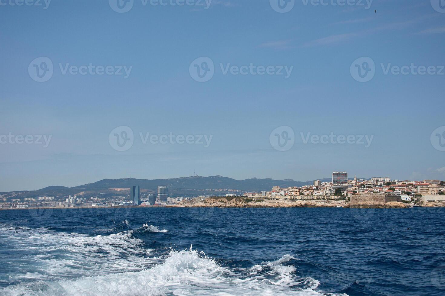 Strolling along the Panier, Narrow alleys and the Port of Marseille in the background, in the evening light. photo