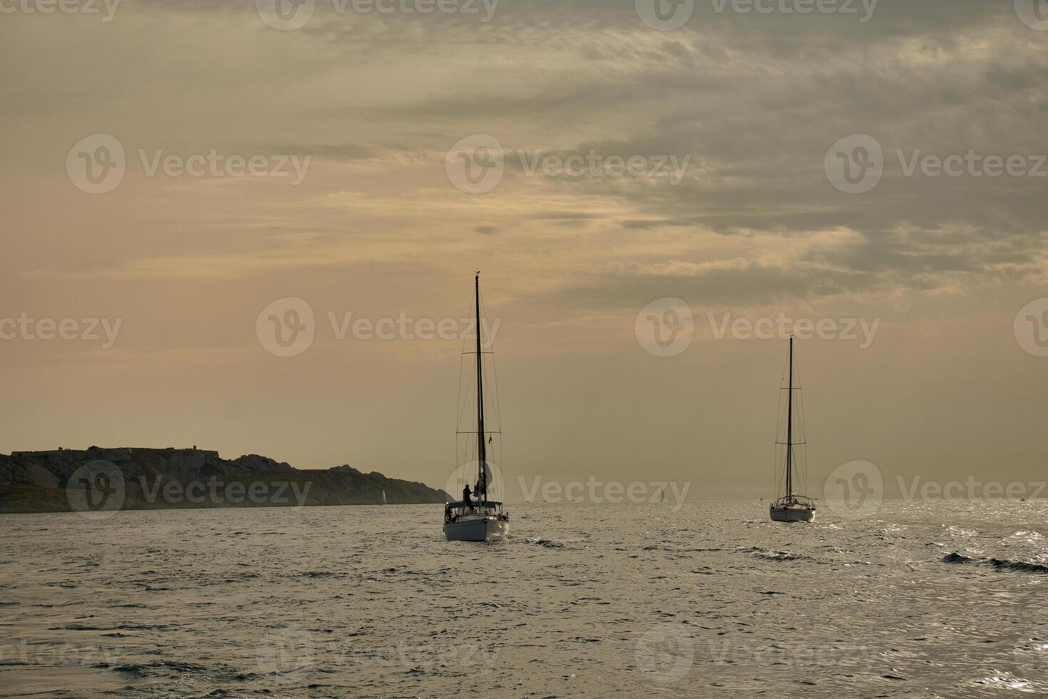 Sailing on the French Riviera with a sailboat in the foreground and multiple boats near Marseille, Provence photo