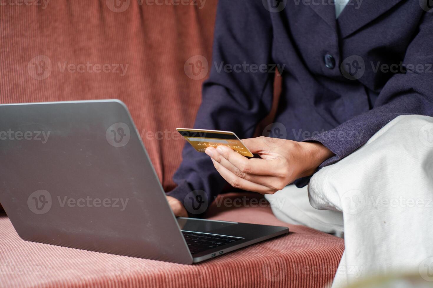 Close-up of a person using a laptop and credit card for online shopping, highlighting e-commerce and digital transactions. photo