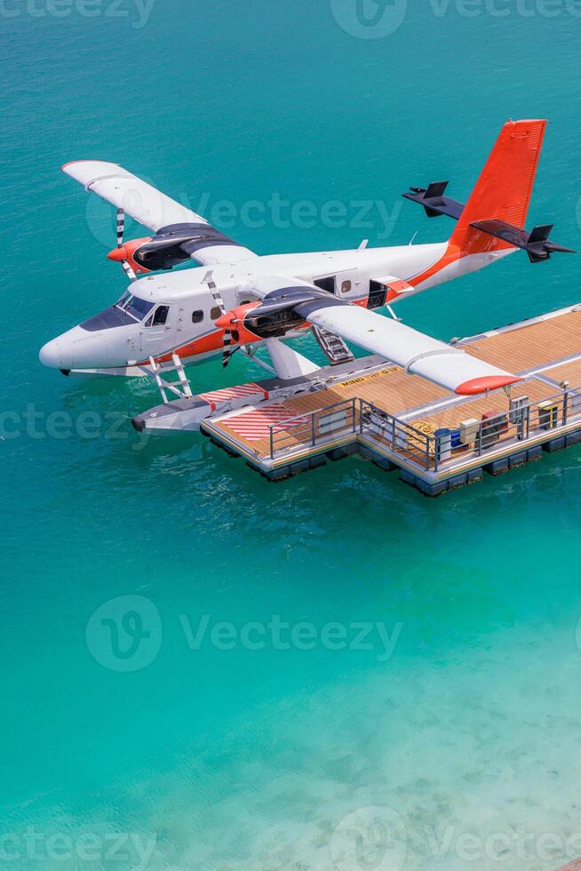 Seaplane on a dock above turquoise water photo