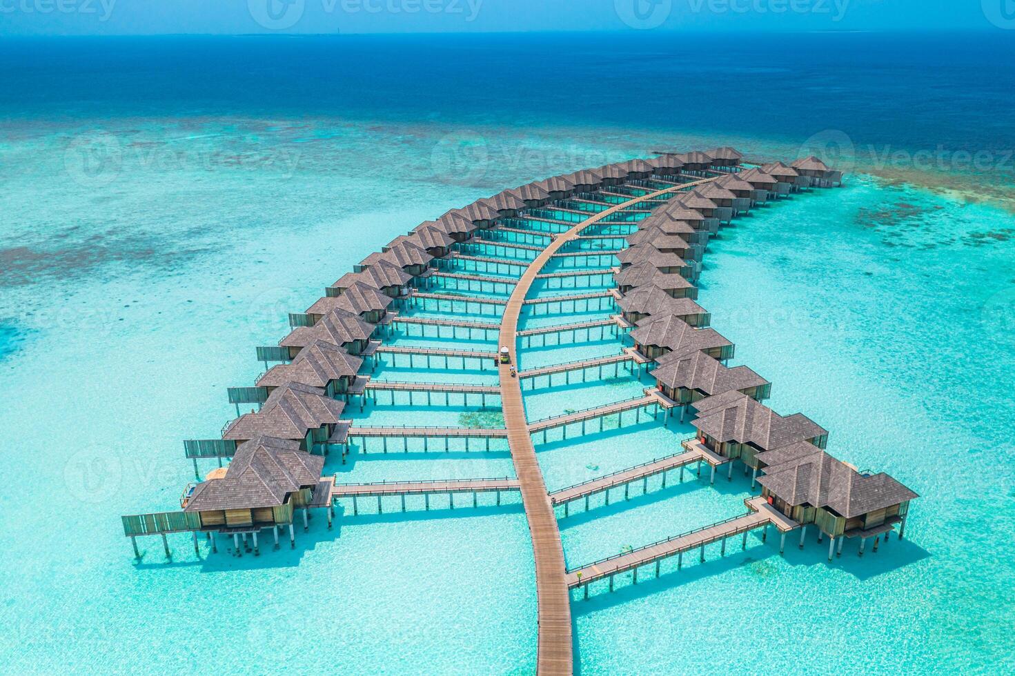 Overwater bungalows in turquoise water photo