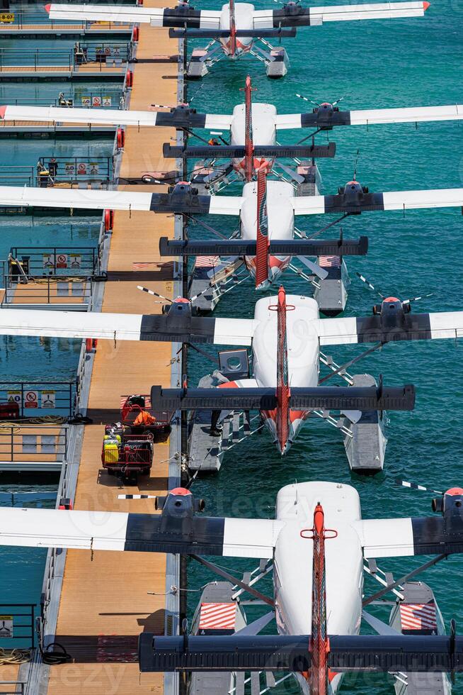 Aerial Maldives seaplane taxi dock on pristine turquoise lagoon tropical island luxury summer travel transportation vacation getaway scenic aerial view exotic paradise escape photo
