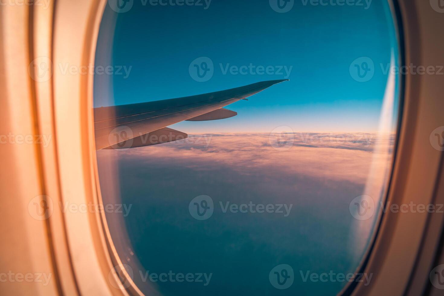 Sunset sky with fluffy clouds seen from airplane window, inspiring peaceful travel moments, vacation adventure, and modern transportation in beautiful aerial scenery photo