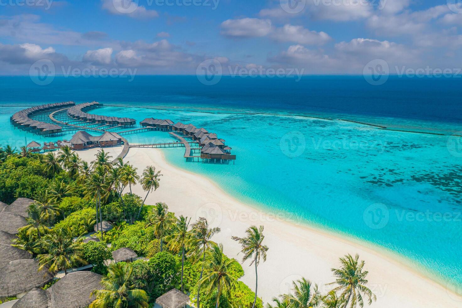 Aerial view of Maldives overwater stays including villas and bungalows with tropical beach landscape, lagoon bay, palm trees, and peaceful summer scenery ideal for luxury travel and island escape photo
