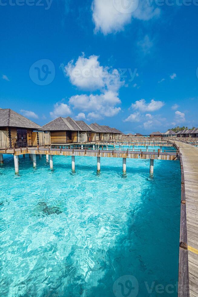 Pristine Maldives ocean lagoon with crystal clear turquoise sea and luxury water villas under sunny skies perfect tropical vacation serene island getaway paradise escape photo