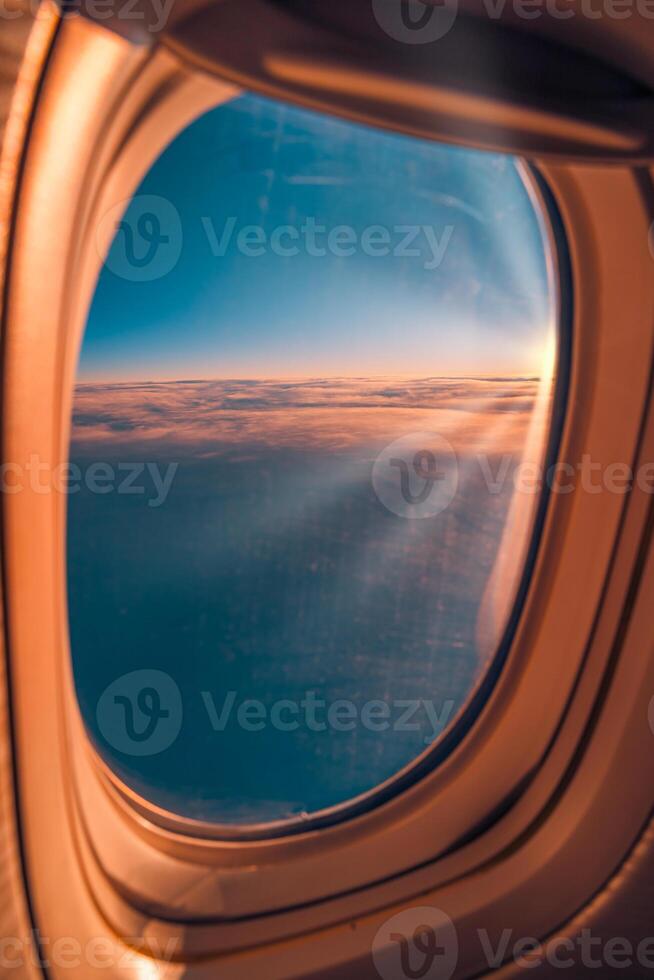 Stunning view from plane window of vibrant sunset and sunrise sky with clouds, capturing serene vacation travel moments, aerial transportation, and breathtaking aerial landscape photo